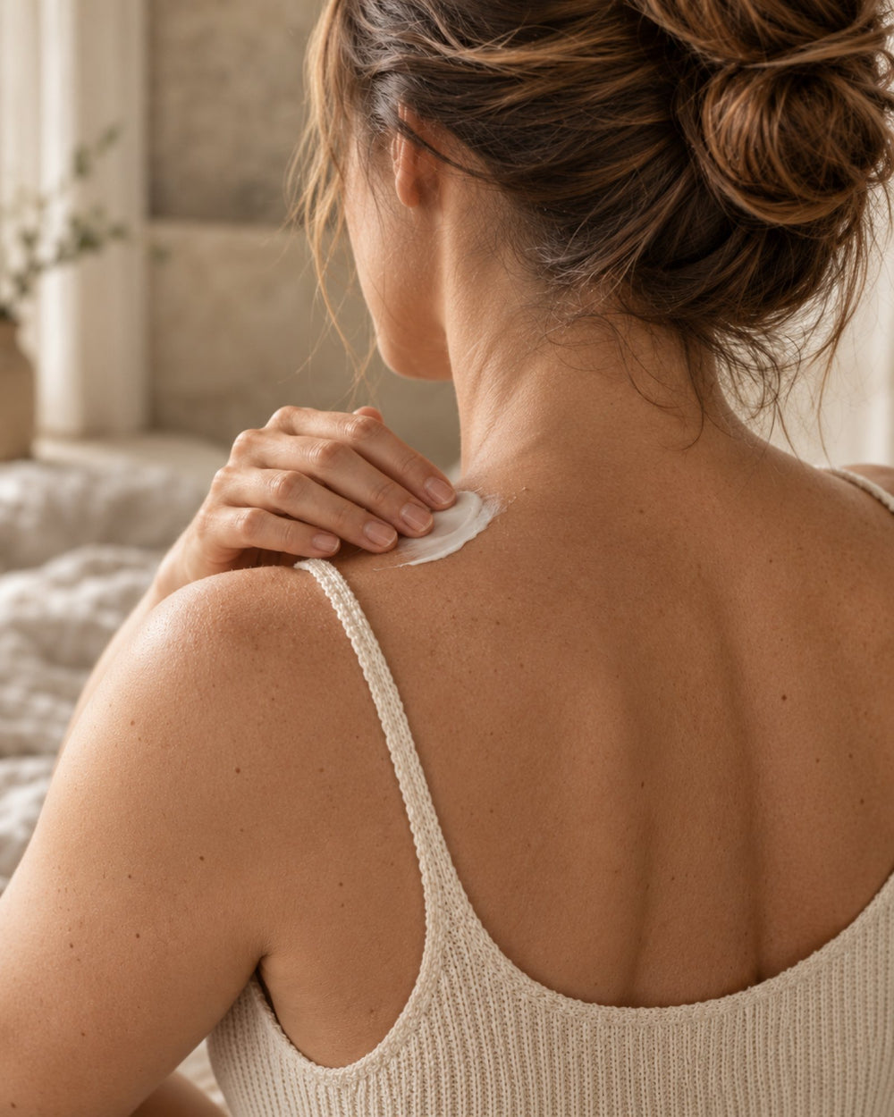 Smoothing YourZone cream onto the neck and shoulder