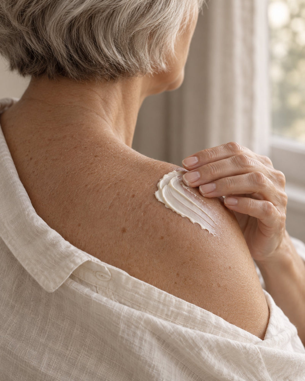 Smoothing YourZone cream onto the shoulder